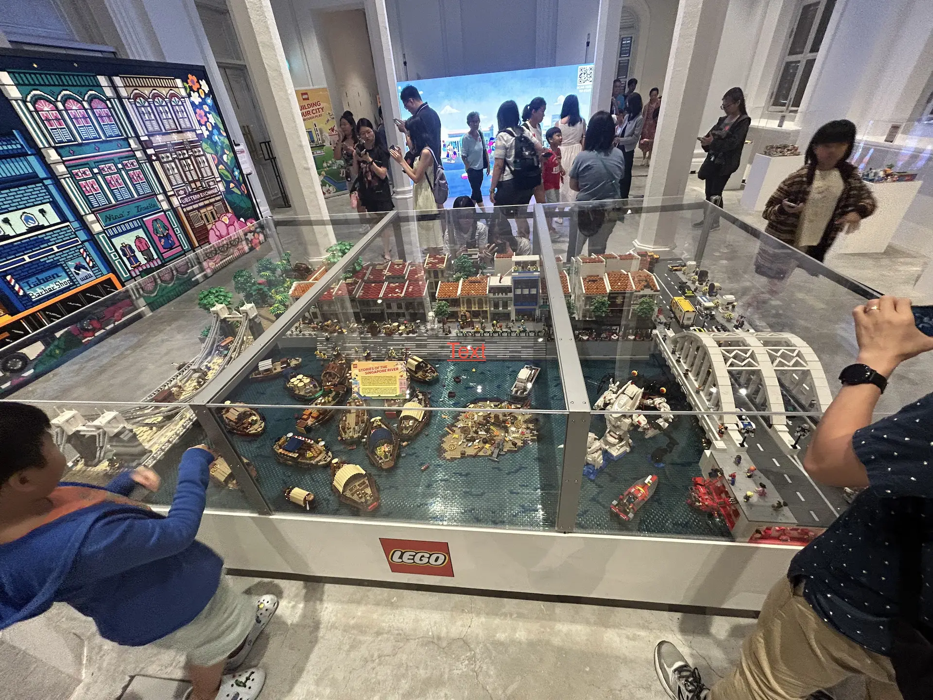 LEGO Stories of Singapore diorama featuring the Singapore River with bumboats and shophouses at National Museum SG60 Exhibition