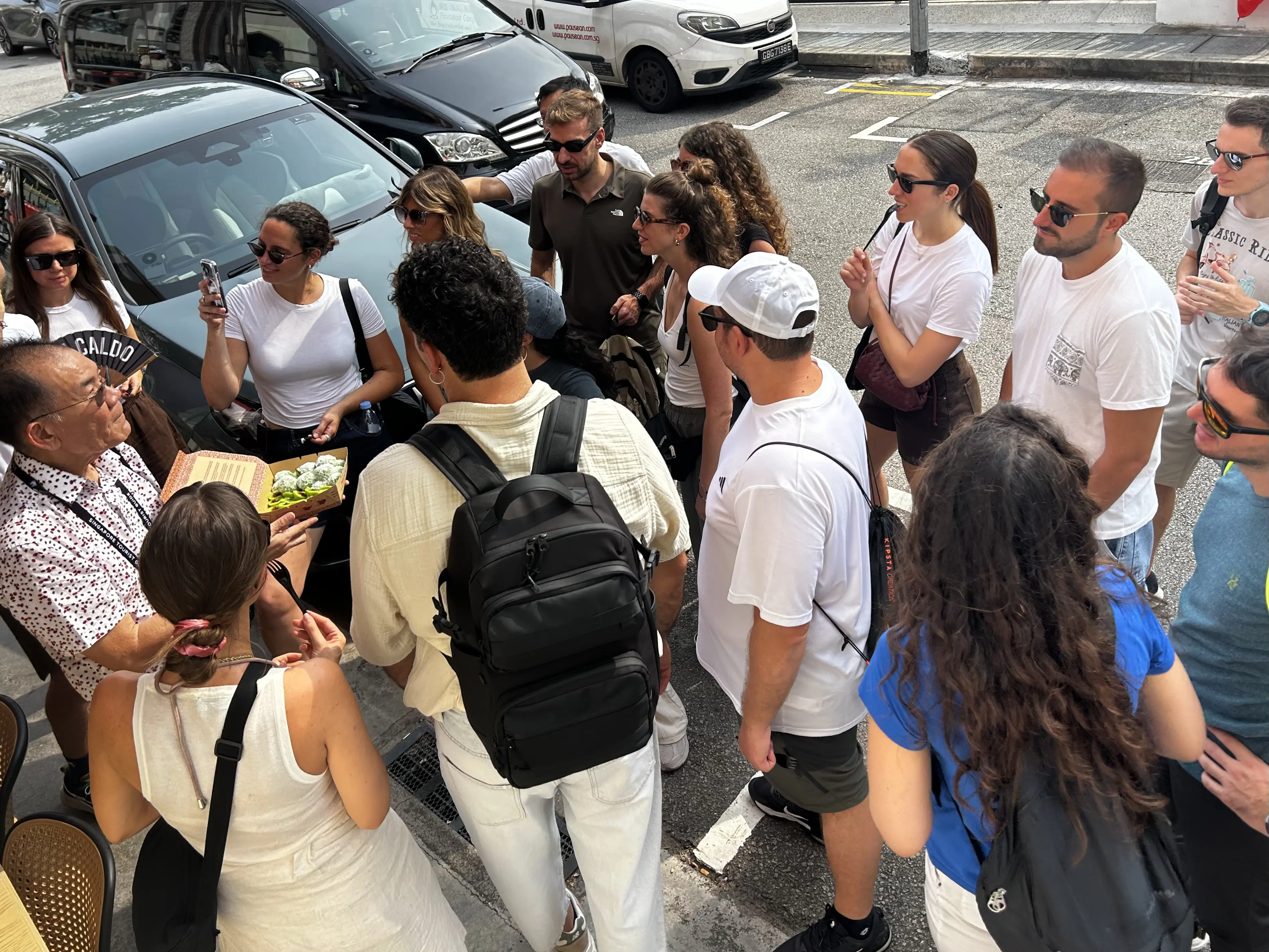 Walking tour guests learning about and tasting traditional kueh
